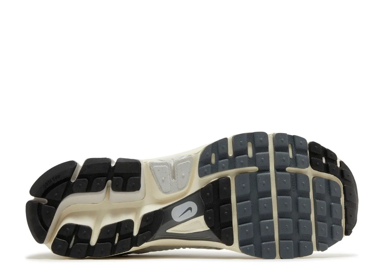 Nike Zoom Vomero 5 Platinum Tint running on uneven ground